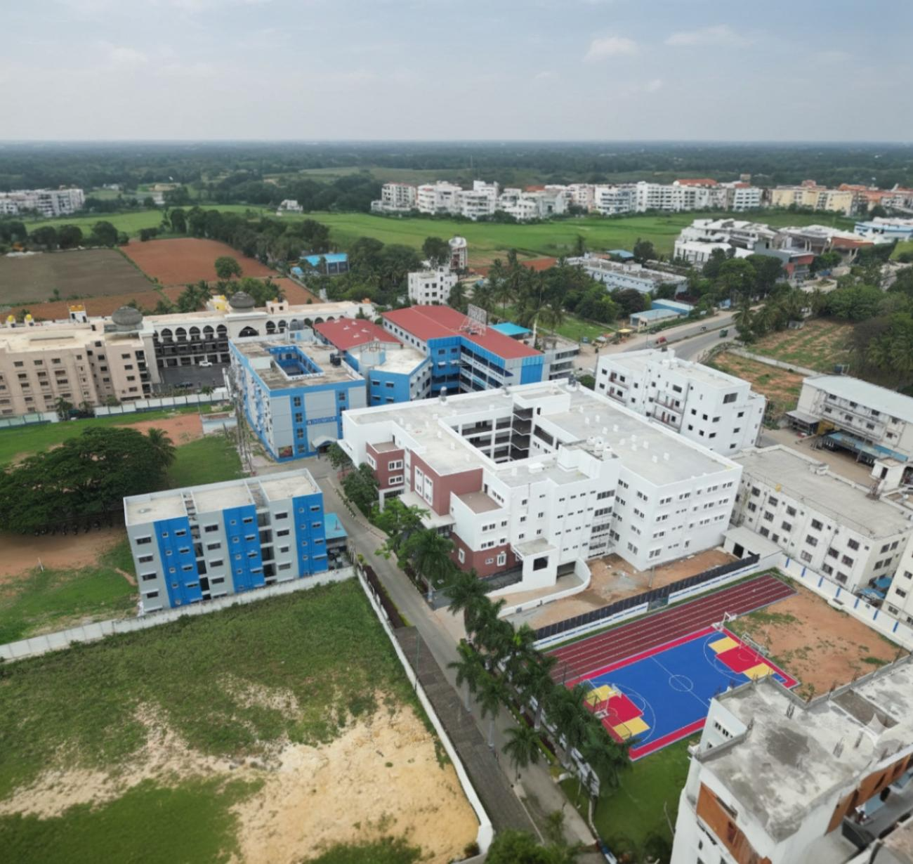 Aerial view of the campus surrounded by the city